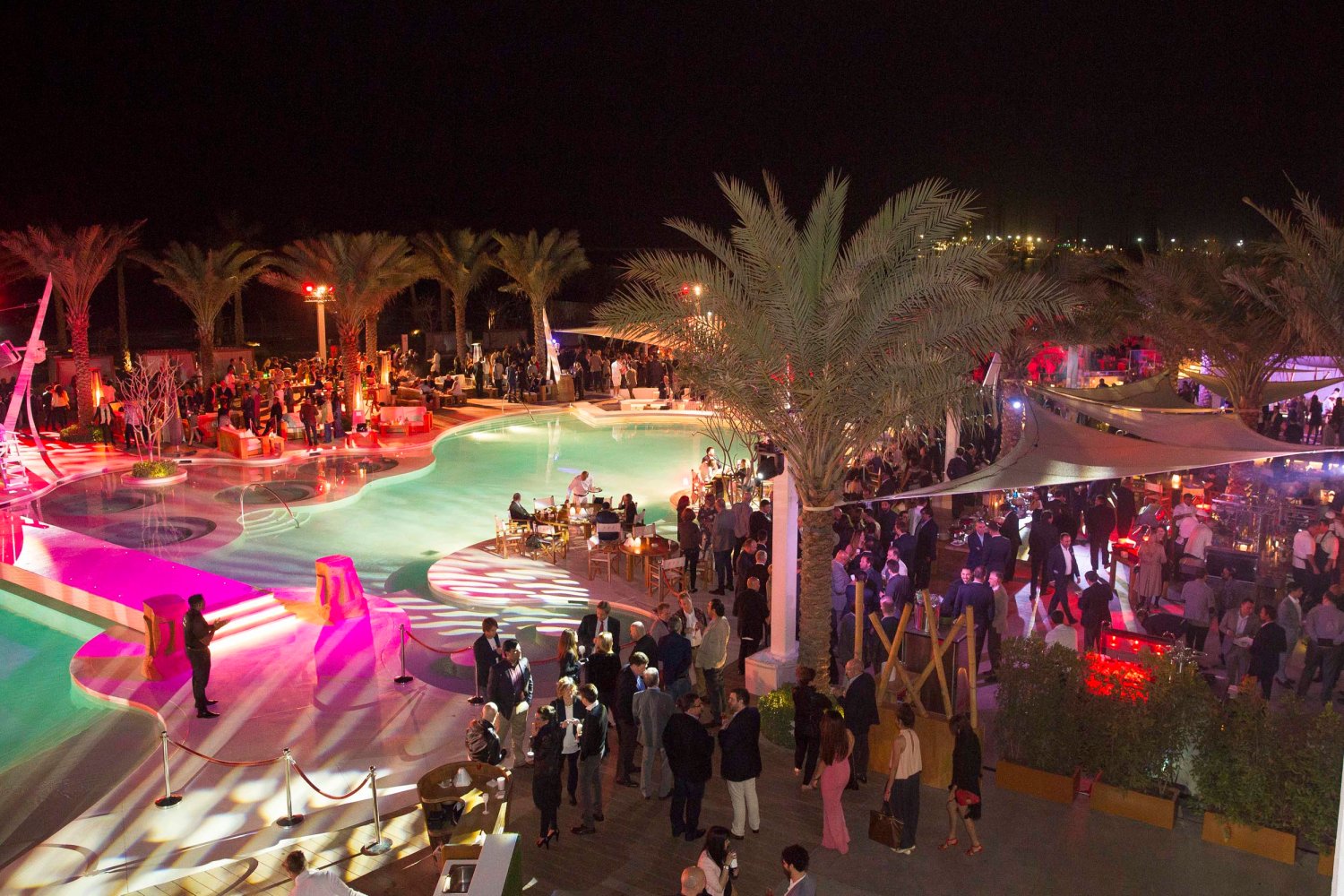 A large evening party around the pool at Nikki Beach