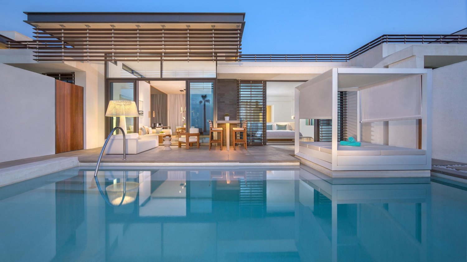 Exterior view of one bedroom beach villa with private pool, sun bed and seating area