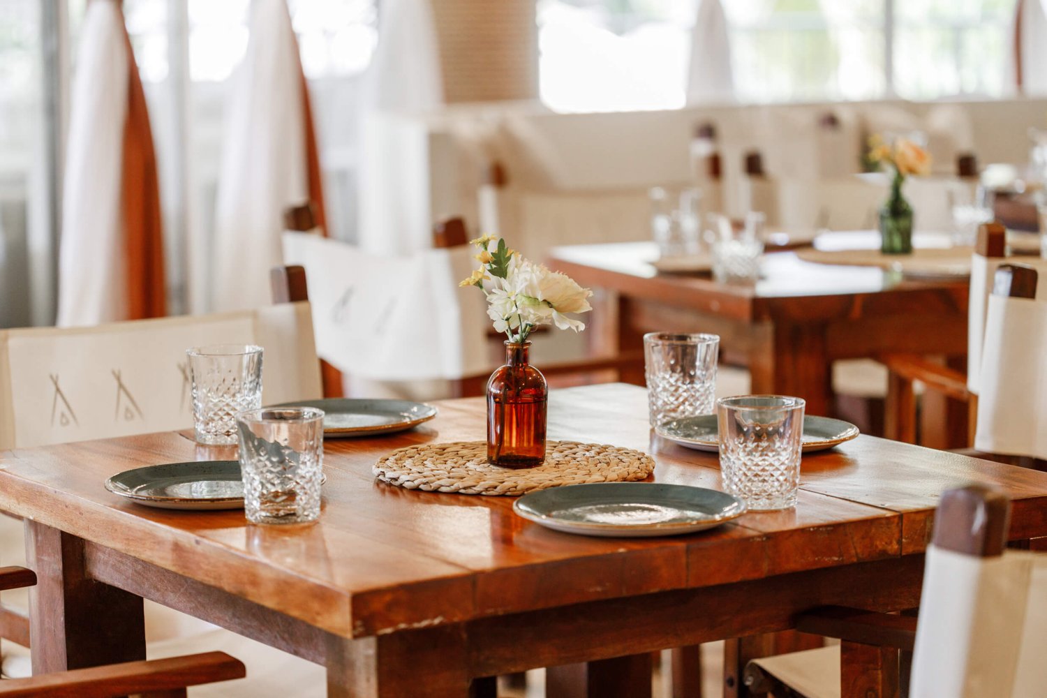 Nikki Beach Miami dining area with tumbler glasses and plates laid
