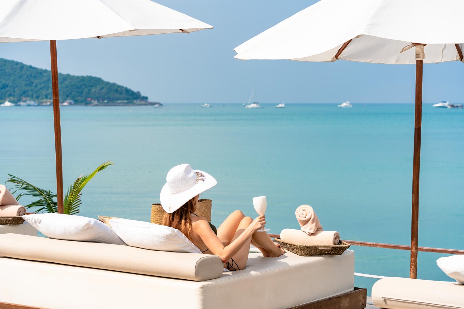 Nikki Beach Koh Samui - Lady lounging on beach front sun bed