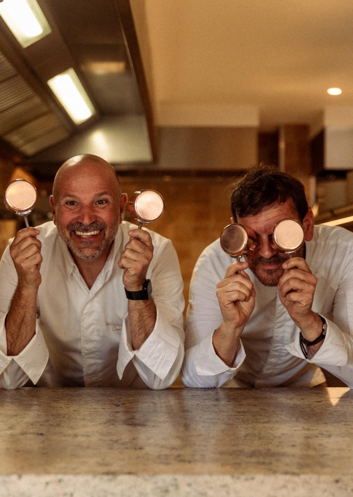 Chefs holding up small pots