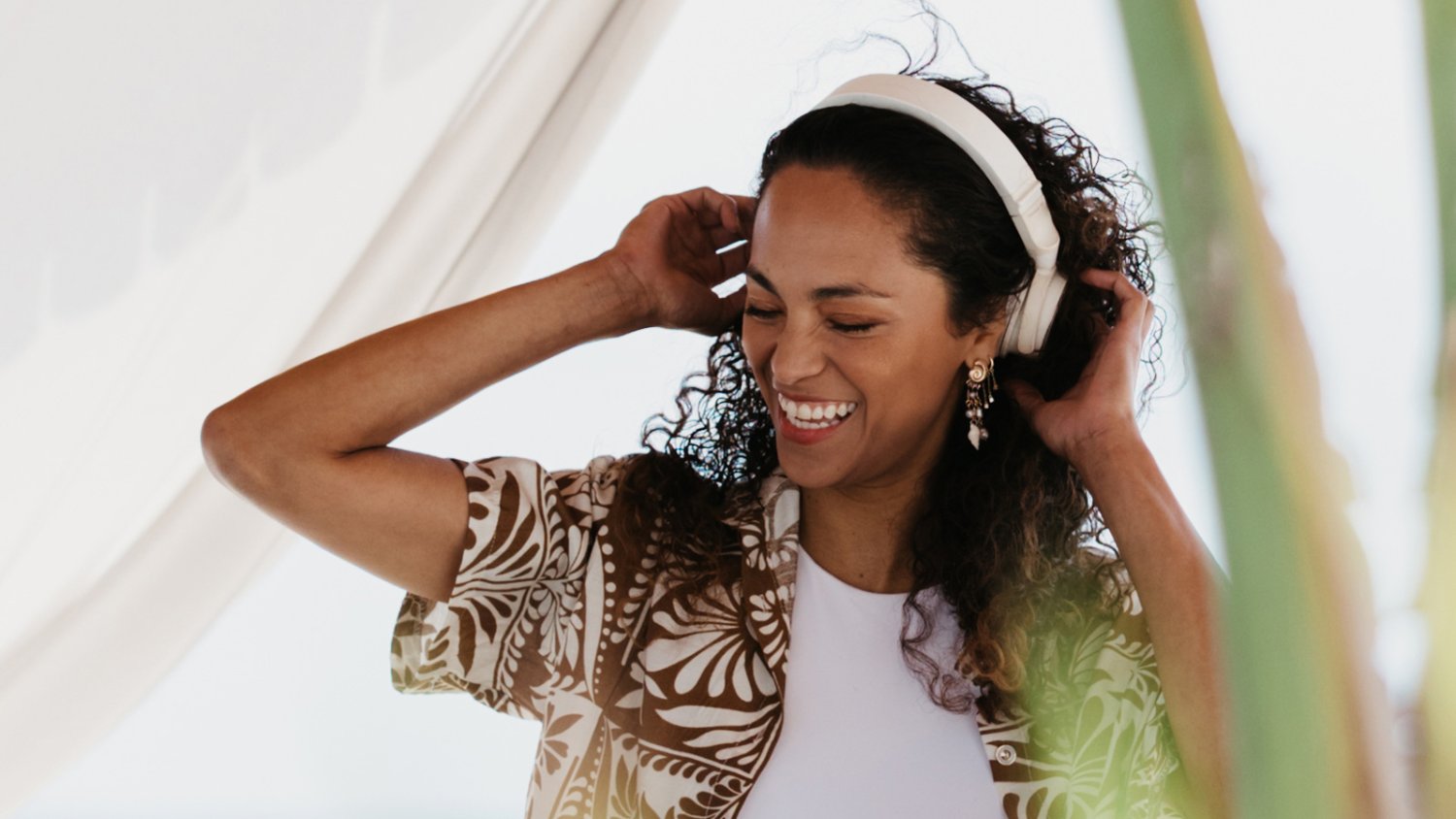 Woman listening to music on headphones happy