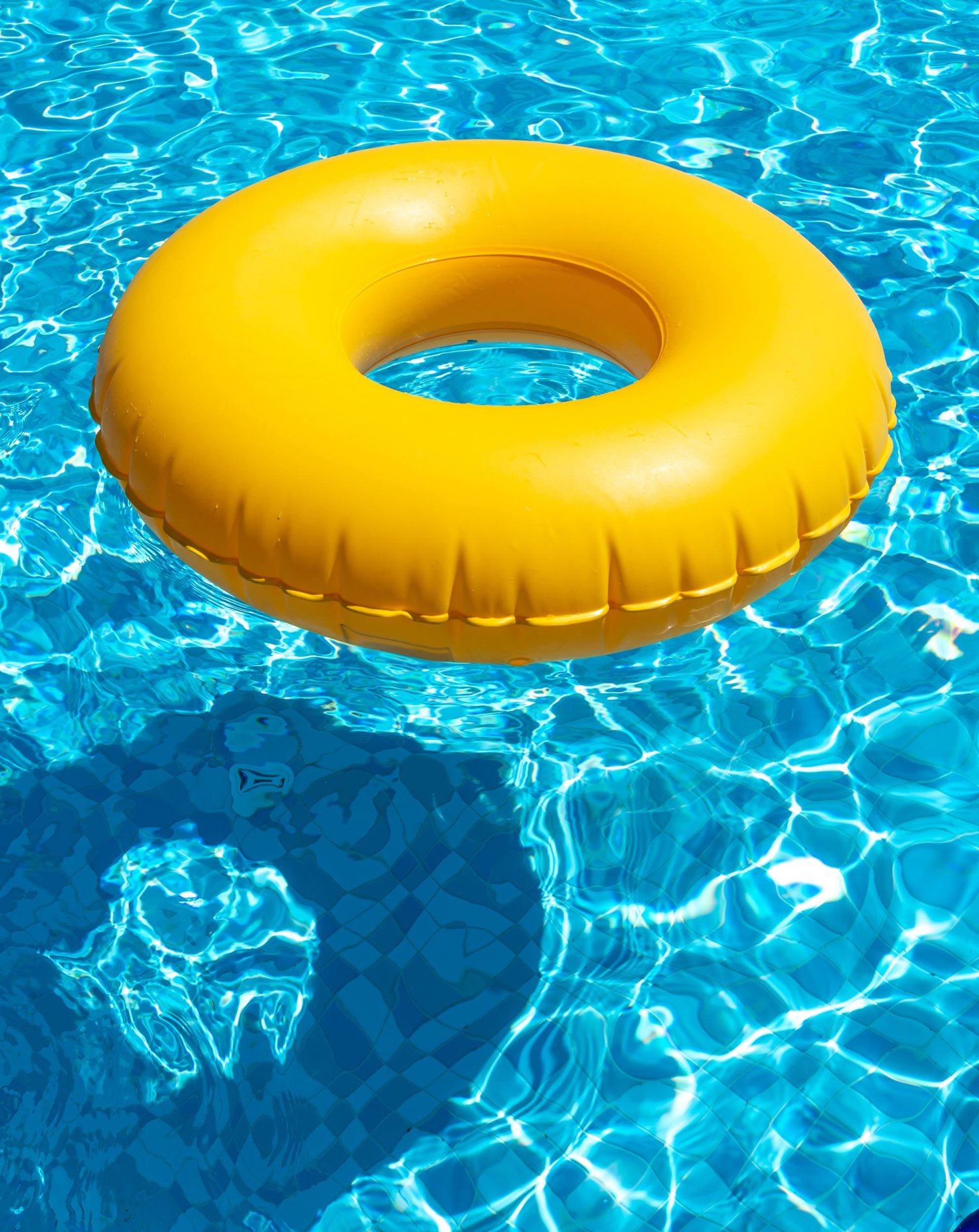 Yellow ring floating in a refreshing blue swimming pool