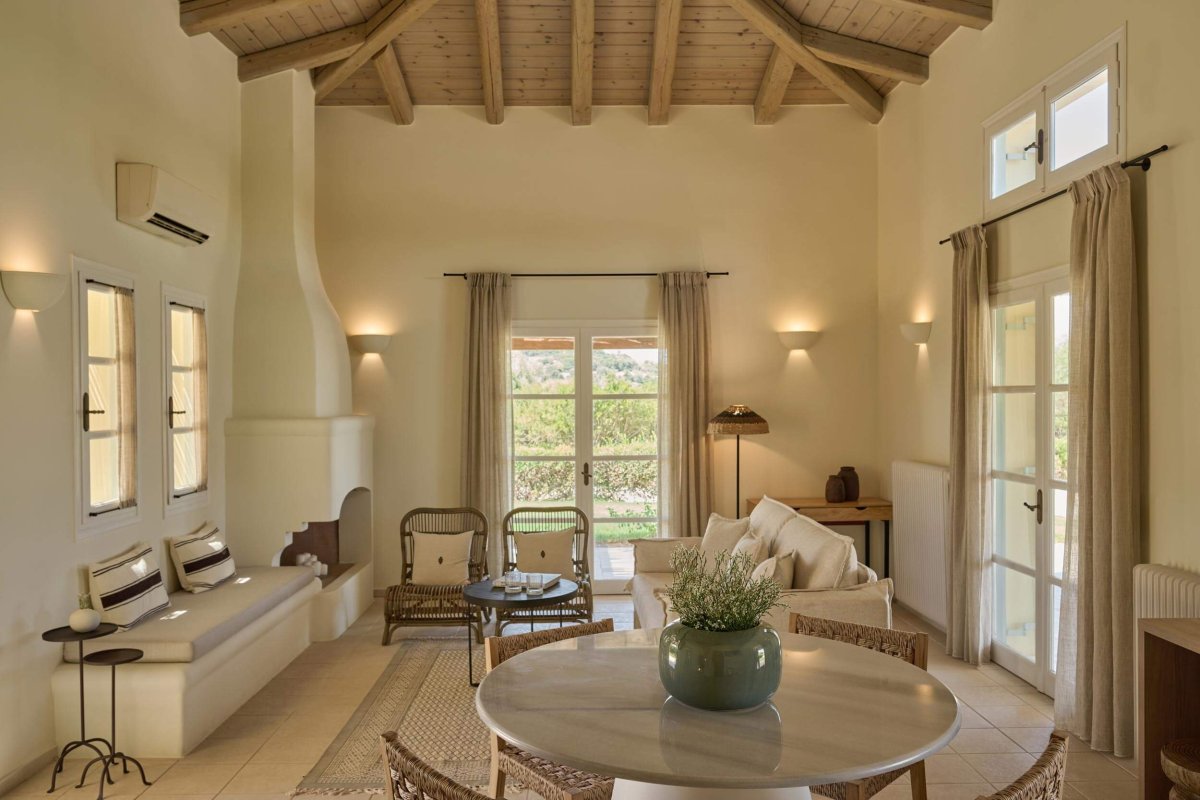 Living/ dining area featuring sofas, arm chairs, fireplace, cabinets and a small round dining table