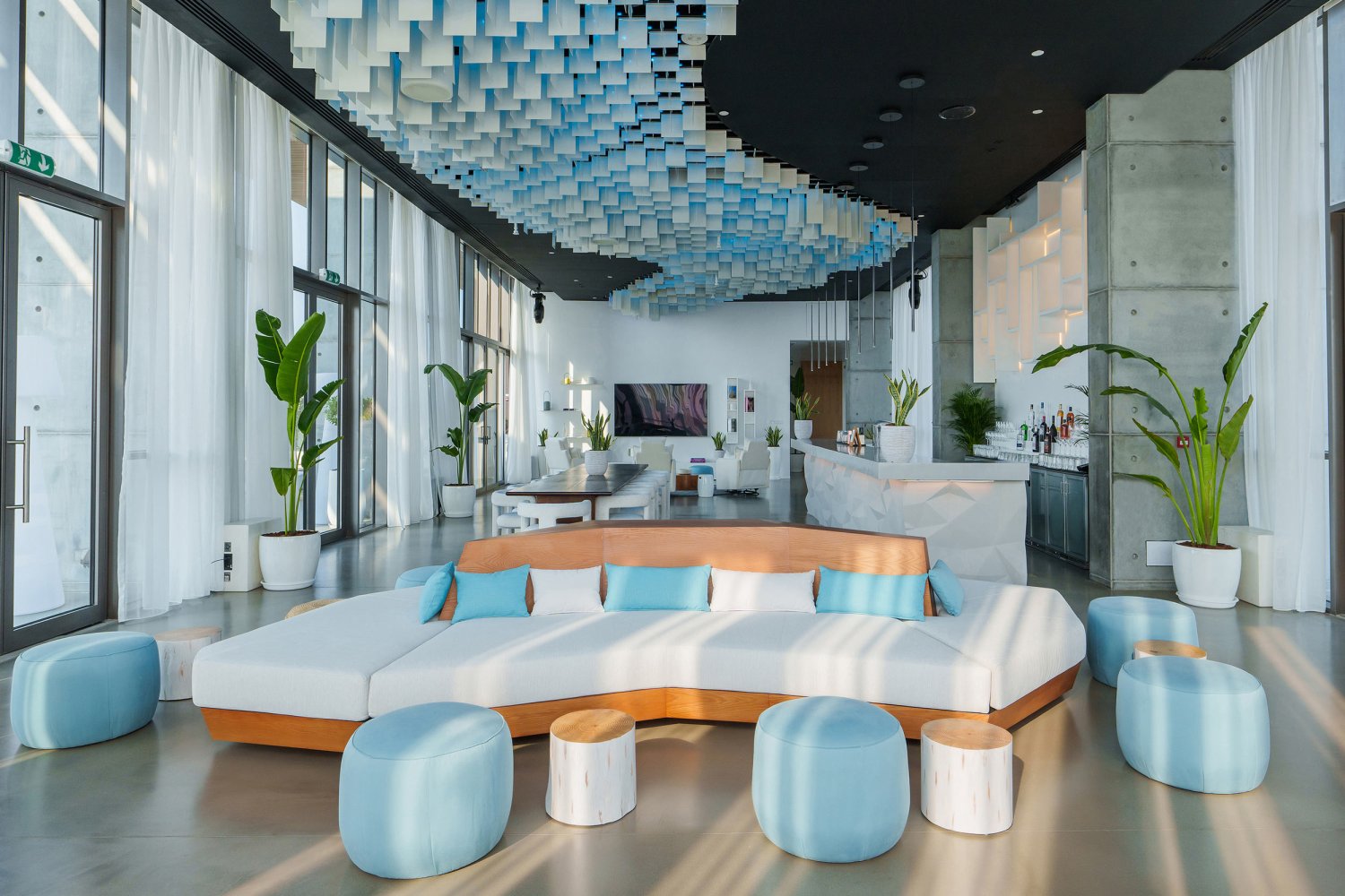 Celebration Suite Living Room Lounge with various seating areas and a bar