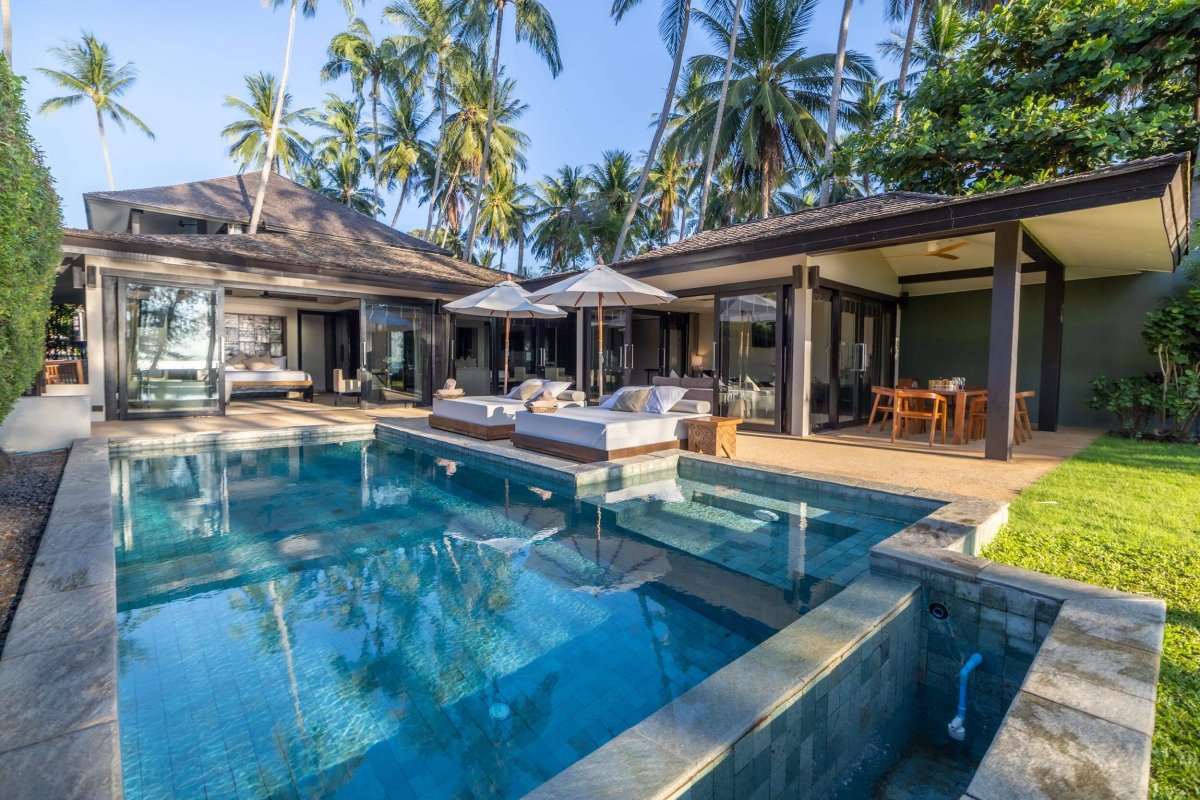 private garden of villa with pool, sun beds and outdoor dining area