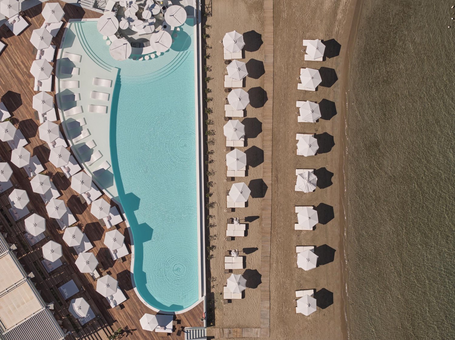 Ariel shot of Nikki Beach resort pool and Porto Heli beach front
