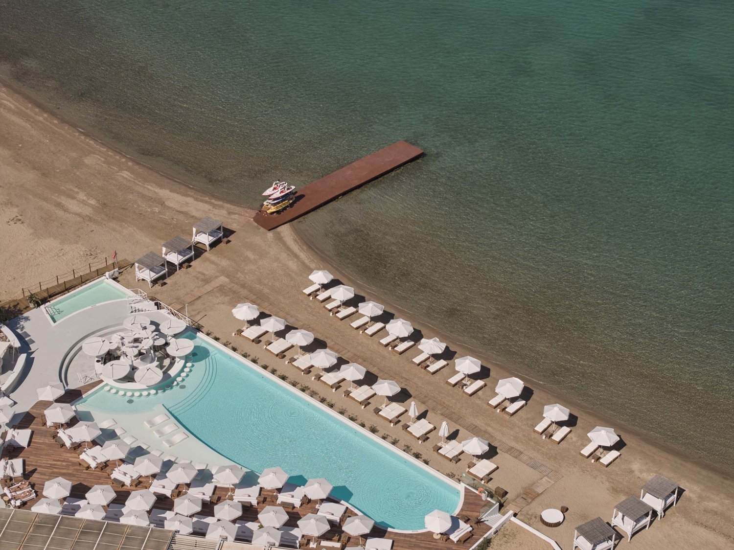 Ariel shot of Nikki Beach resort pool and Porto Heli beach front