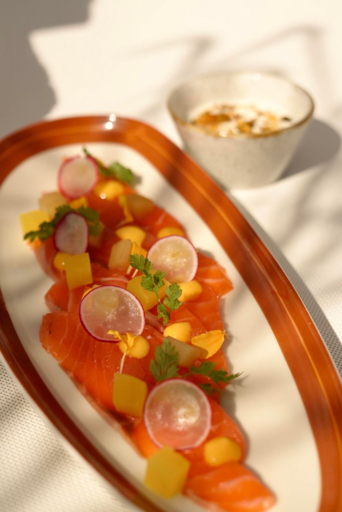 A small plate of salmon with garnish