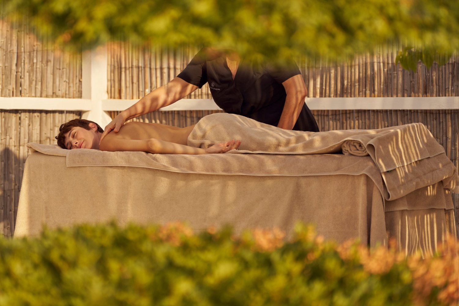 A person receiving a massage by a masseuse