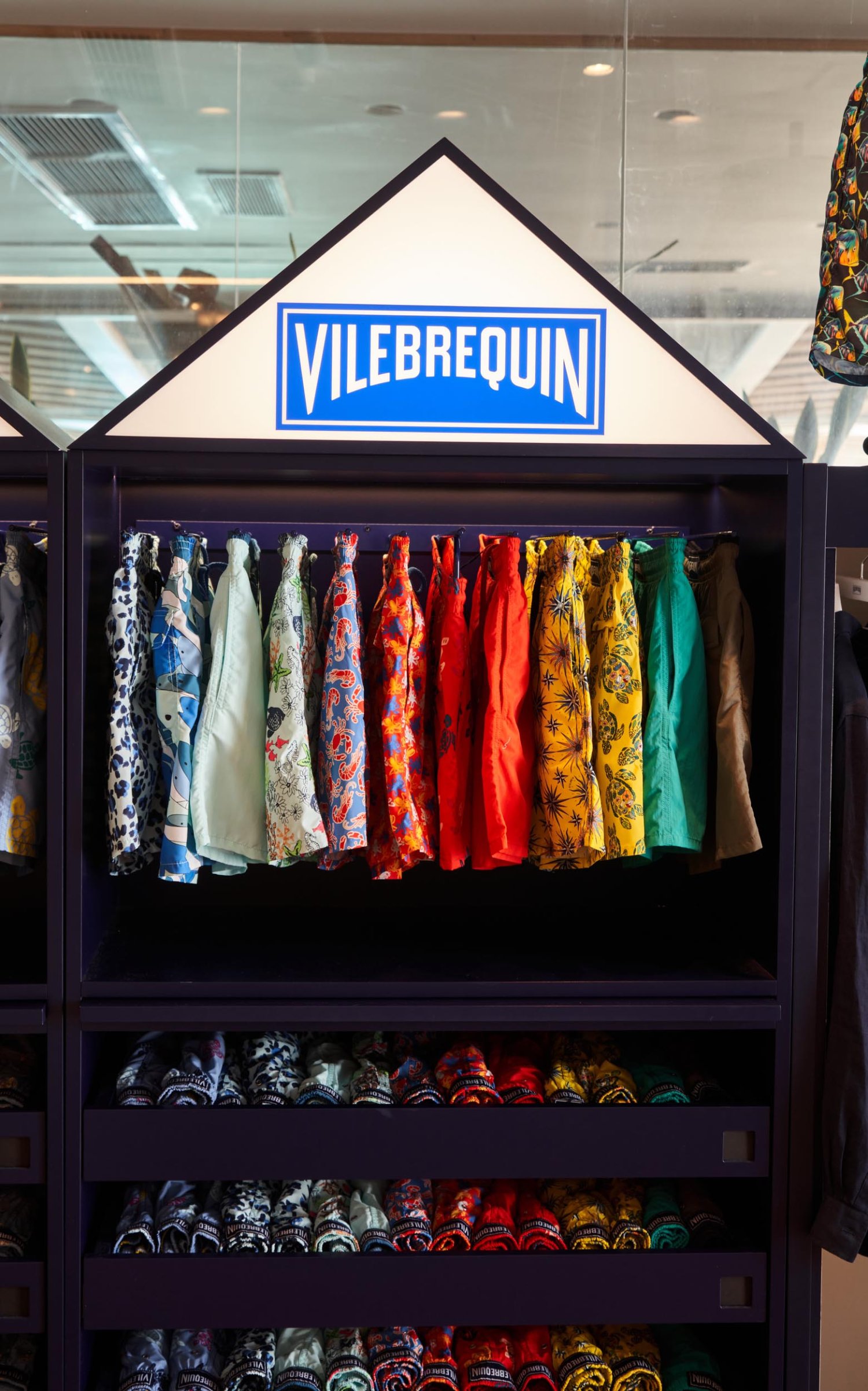 Vilebrequin shorts in a shop stand and open shelving unit