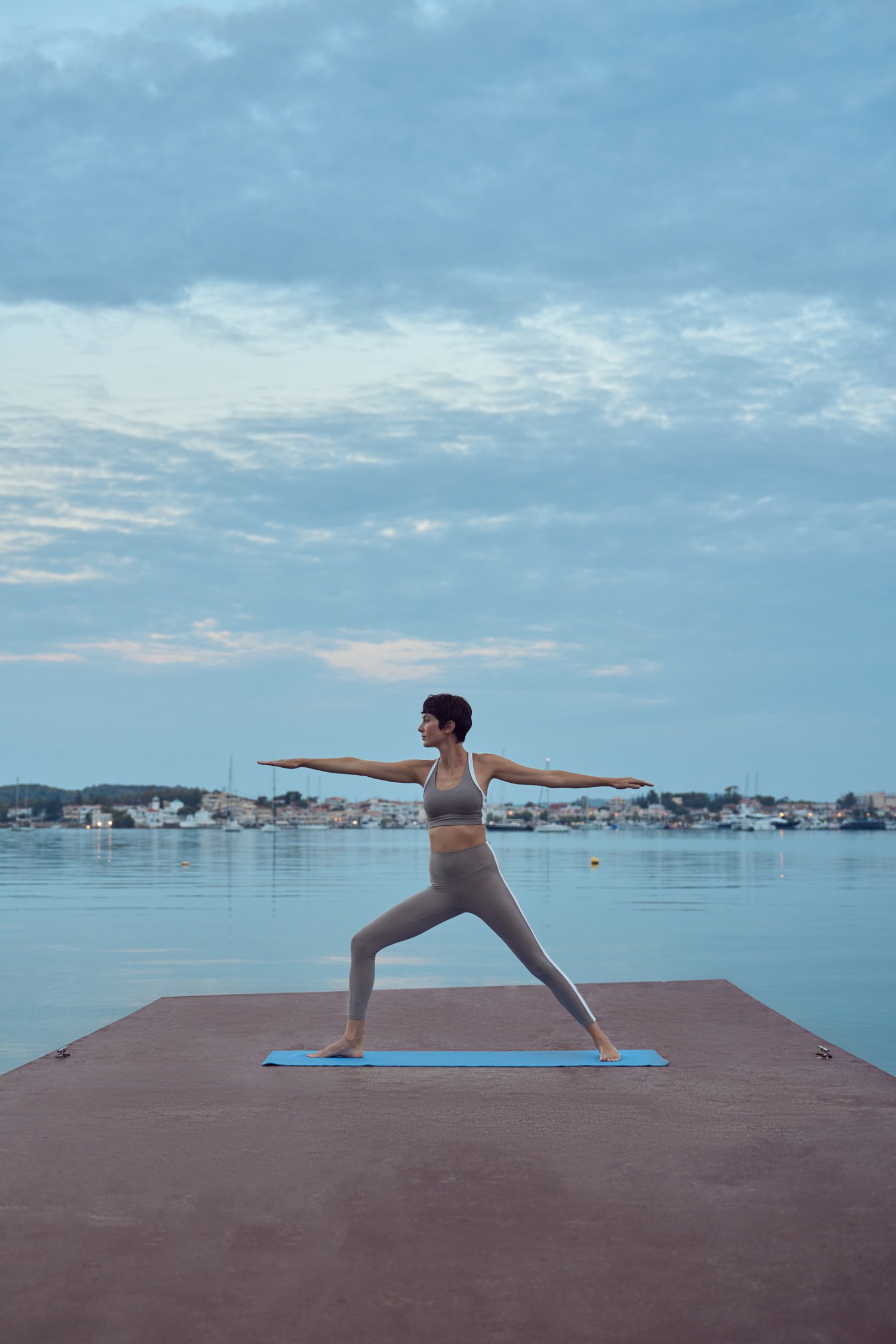 A women doing yoga by the sea