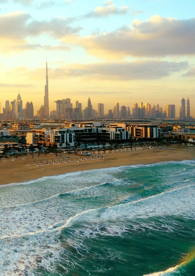 Ariel shot of Dubai showing the sea, beach and buildings in the distance