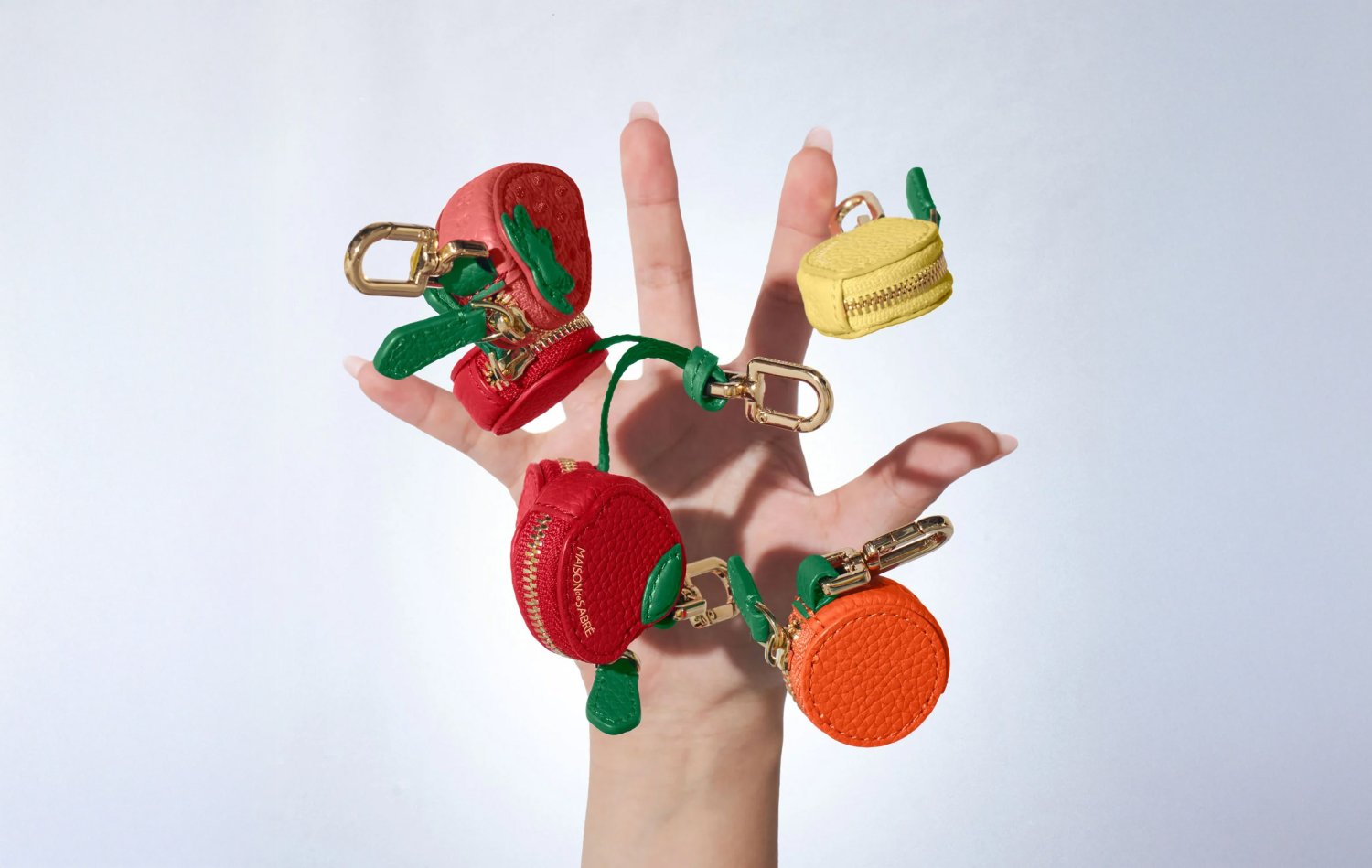 Artistic shot of a hand catching mini leather charms