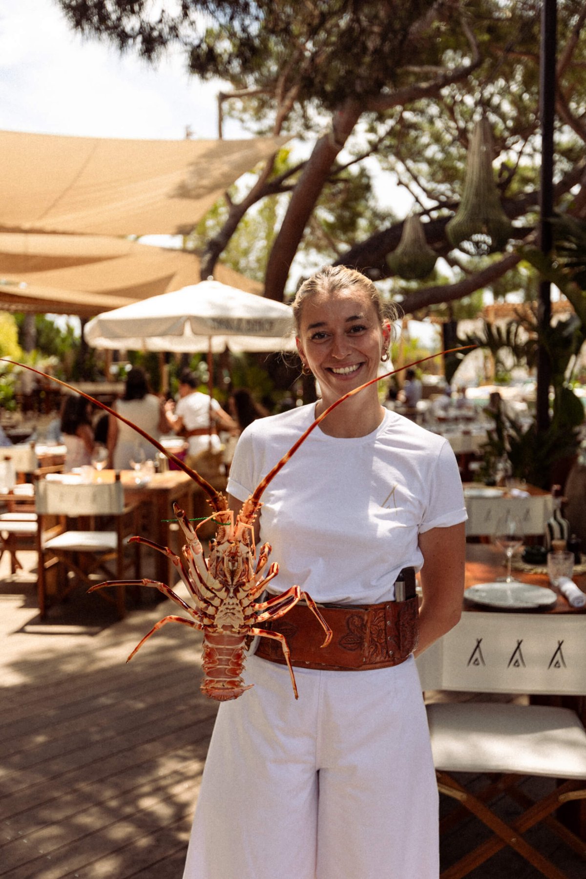 Waiter at Nikki Beach holding up a large lobster