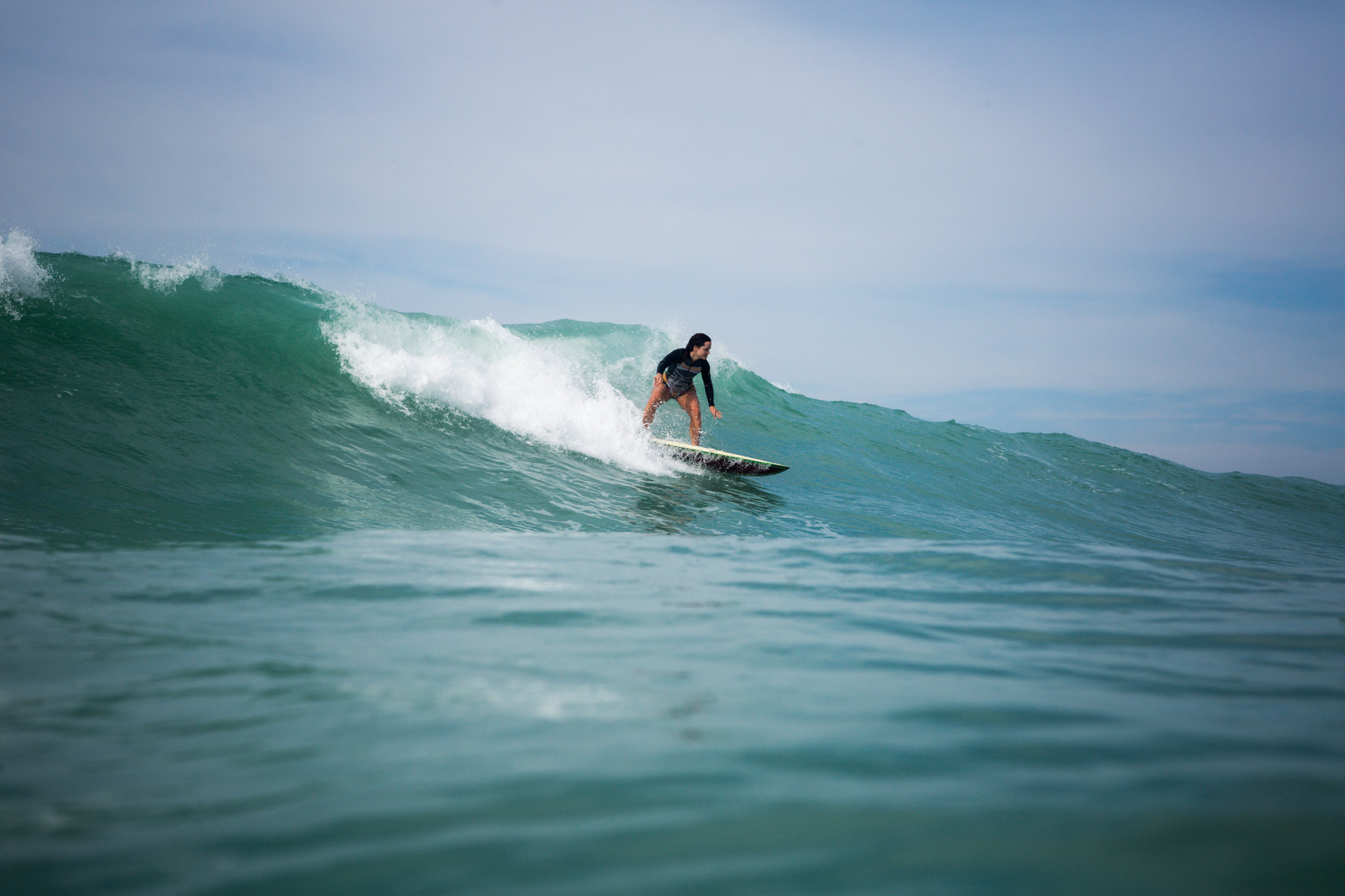 A women surfing a wave in the sea