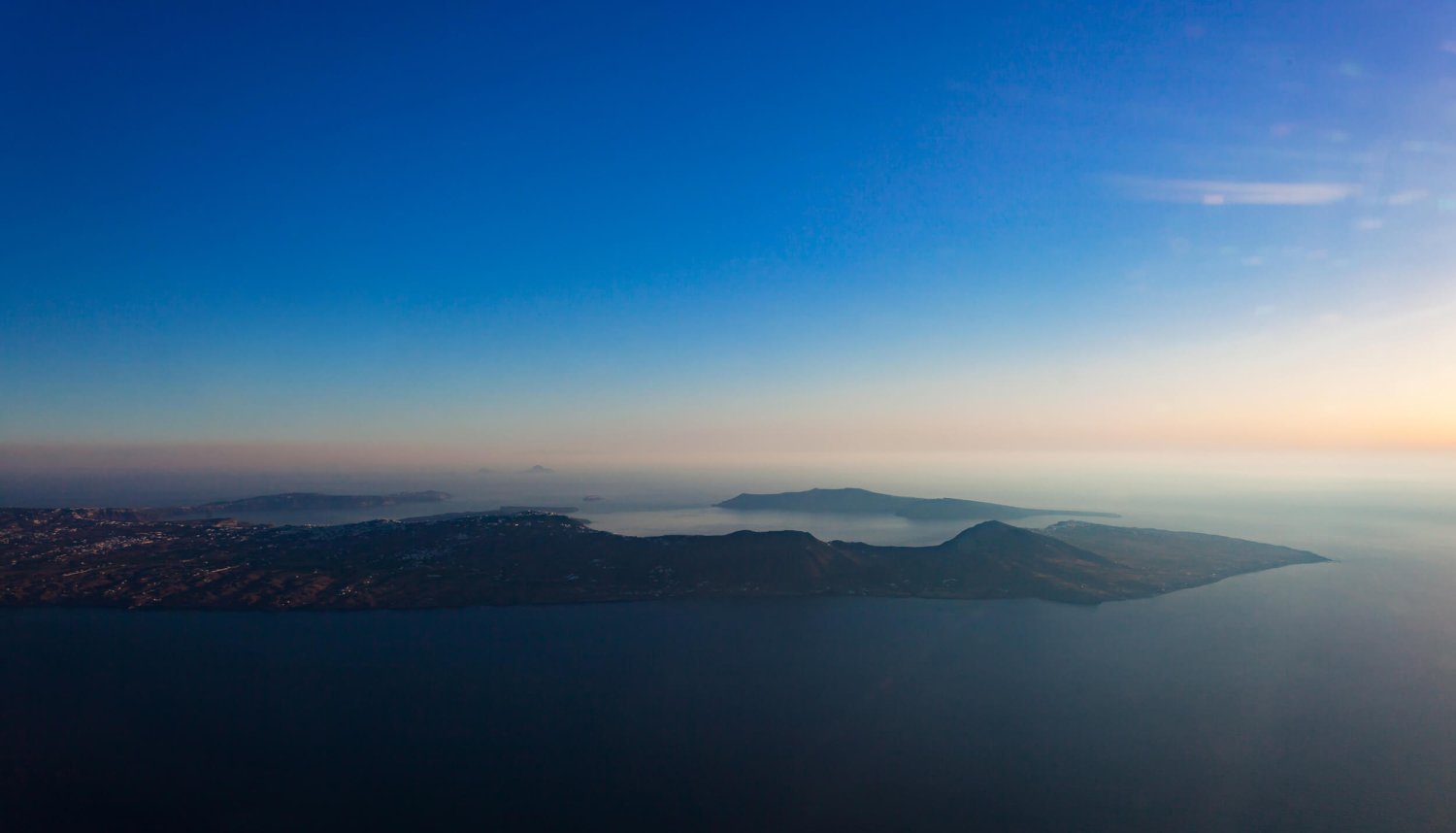 Landscape drone shot at sun set in Santorini over the sea