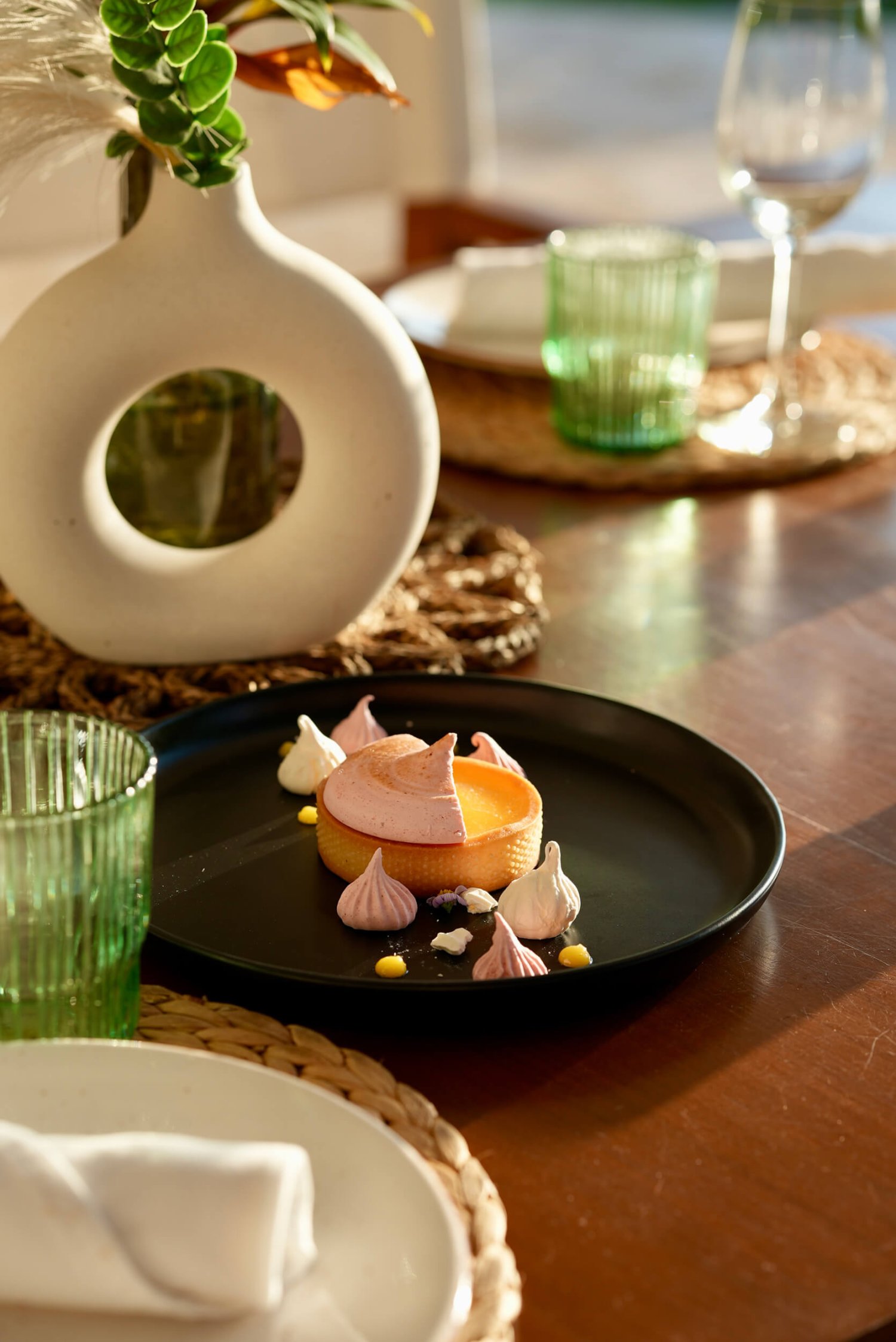 Appetizer on a black plate on a decorative table