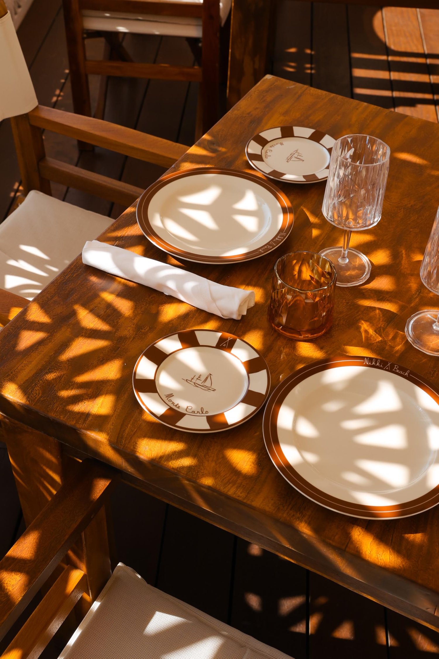 Overhead shot of a laid table with plates, napkins and glasses