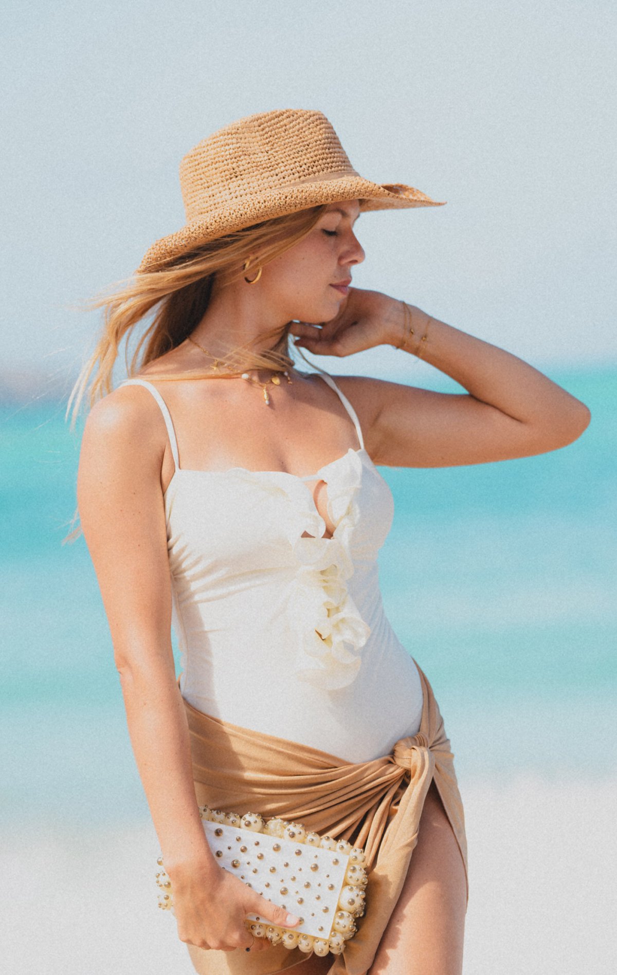 Women posing in bikini and straw hat