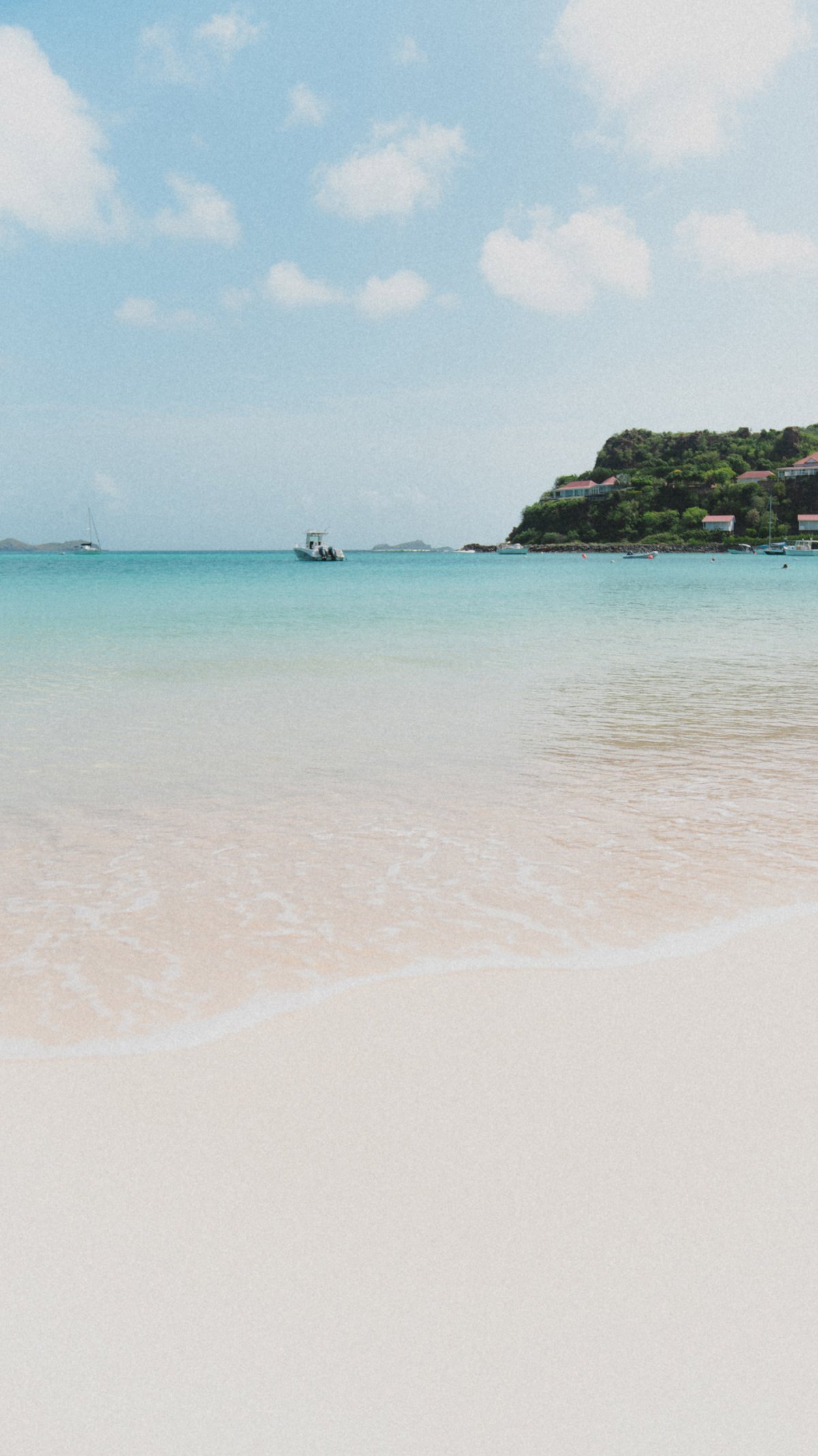 A sandy beach with clear blue sea