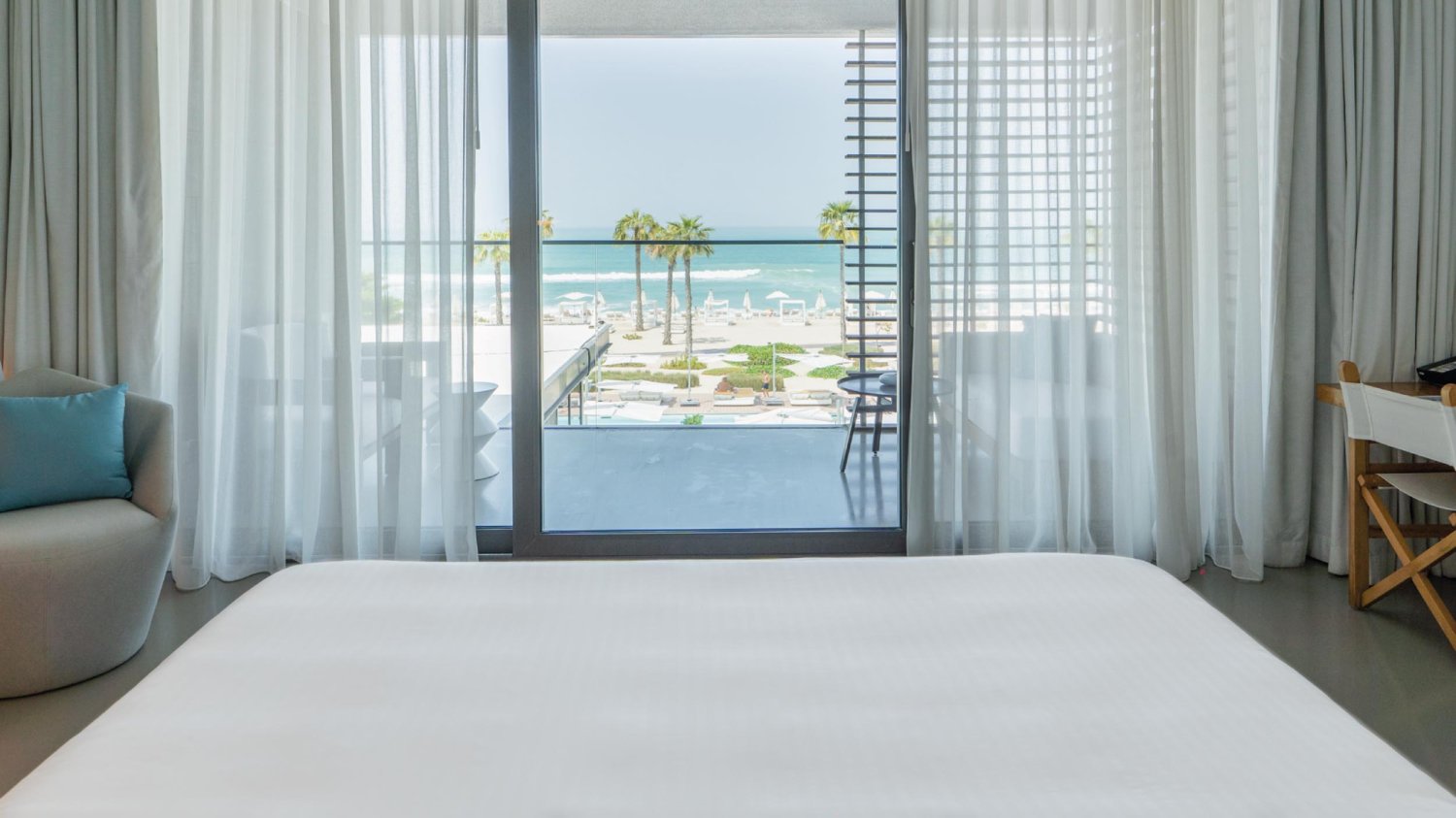 King sized bed looking out to sea view on the balcony