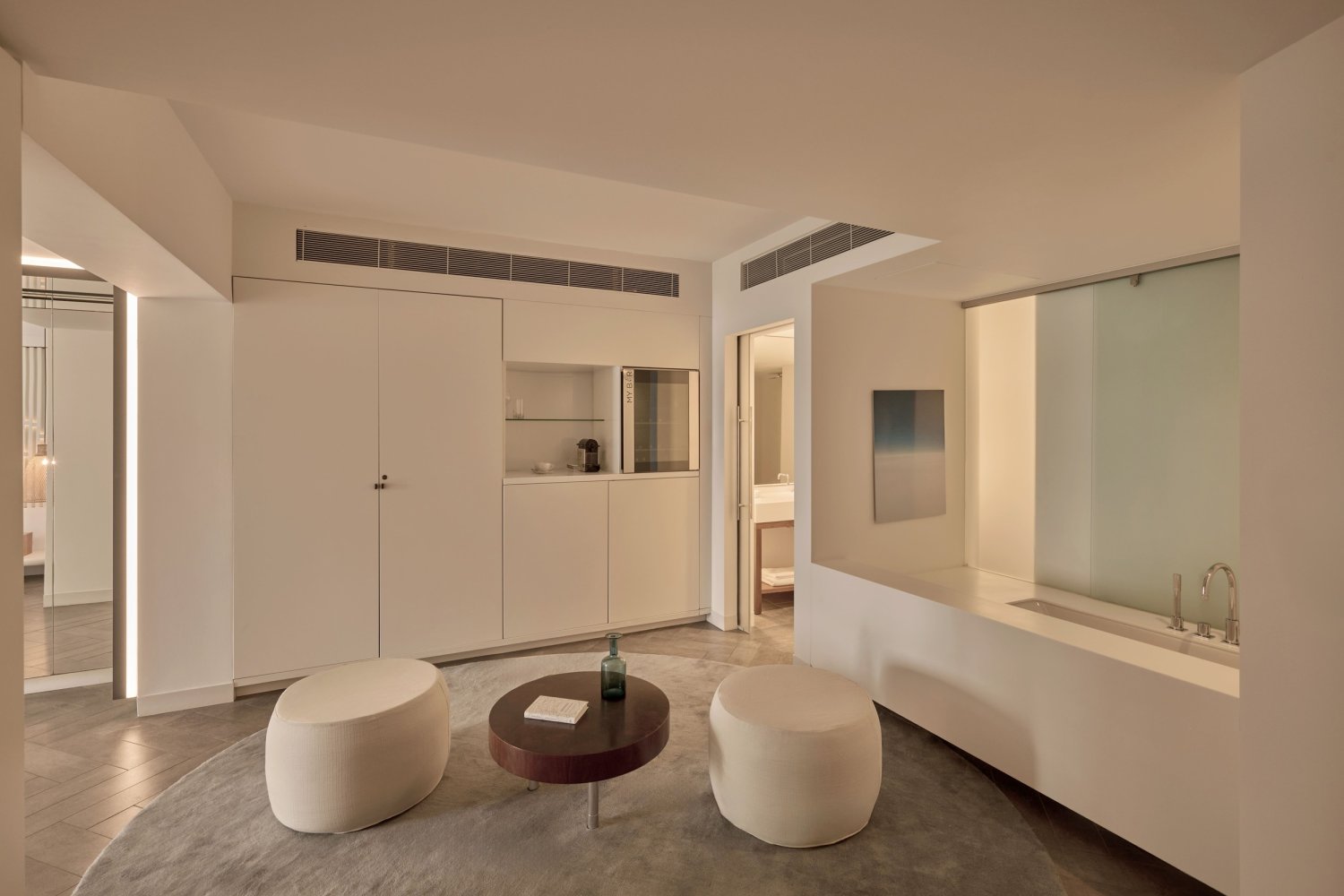 A sophisticated hotel room featuring a spacious bathroom and a private balcony, providing magnificent views for a peaceful escape