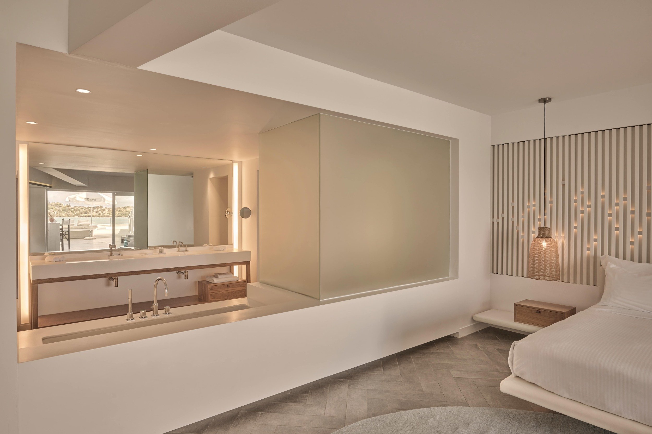 A luxurious hotel room featuring a large mirror, designed for relaxation and coastal elegance at Nikki Beach Porto Heli