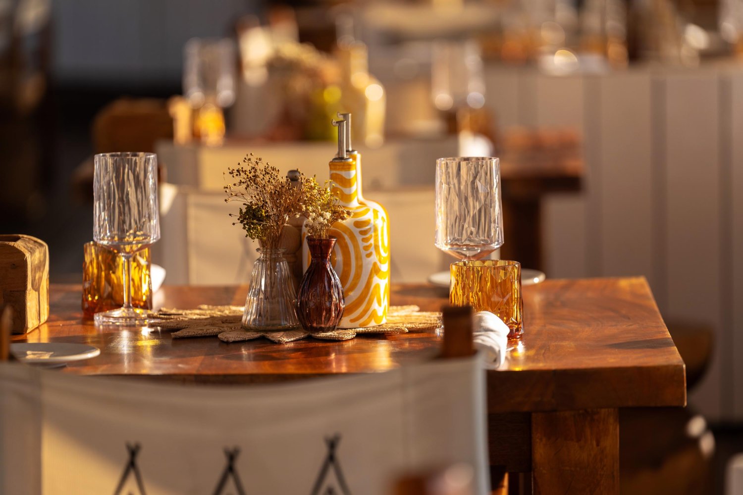 Nikki Beach Monte Carlo dining area with tumbler glasses and plates laid