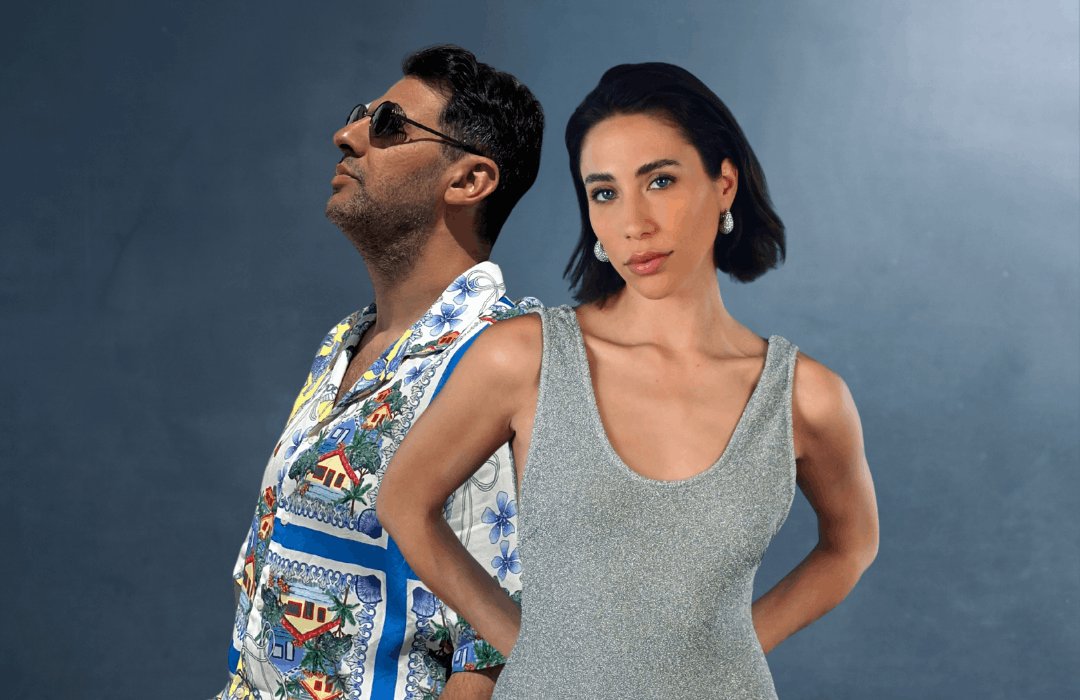 A promotional portrait of musical duo Nasiri & The Singer against a cool blue backdrop. On the left, multi-instrumentalist Constantin Nasiri stands in profile wearing sunglasses and a vibrantly patterned shirt, while the live vocalist stands confidently on the right in a shimmering silver top. This striking image perfectly sets the tone for their upcoming June 19th performance, promising an elevated evening of immersive music and soulful energy at the Qurio rooftop bar