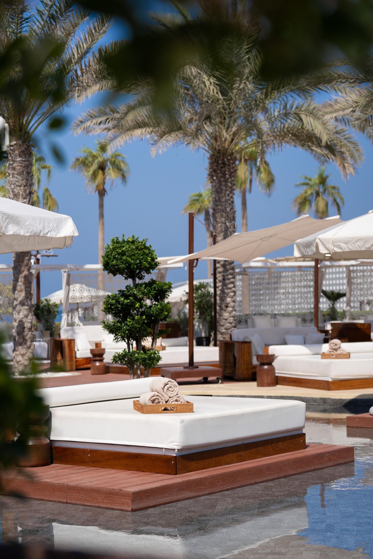 Sun bed surrounded by shallow pool of water