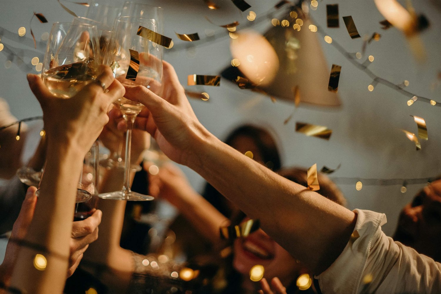 Guests raise their champagne glasses in a toast, celebrating amidst a lively party atmosphere