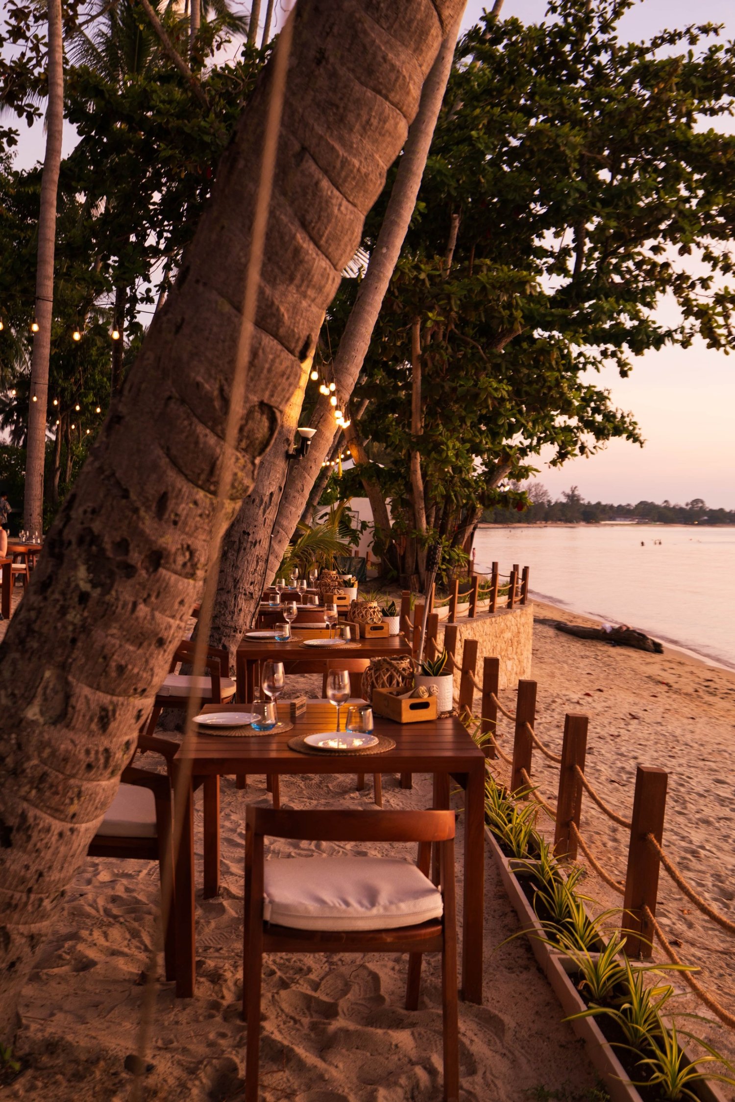 A beautifully arranged table with luxurious chairs, perfect for a romantic dinner at Nikki Beach Resort & Spa Koh Samui