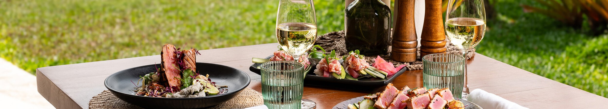 A beautifully set table featuring two elegant plates of gourmet food, exuding luxury and sophistication