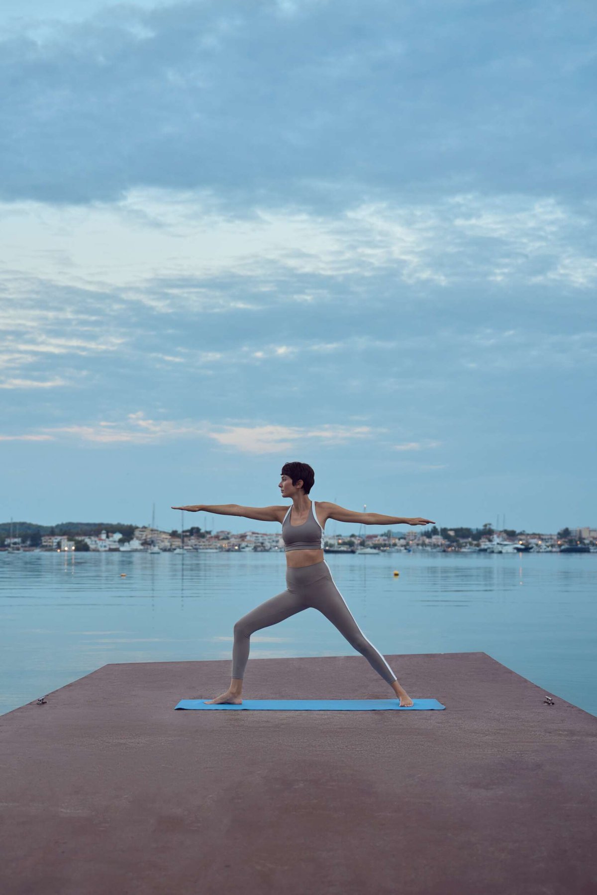 Early light, calm waters, and perfect balance — yoga by the dock as the Greek Riviera slowly wakes