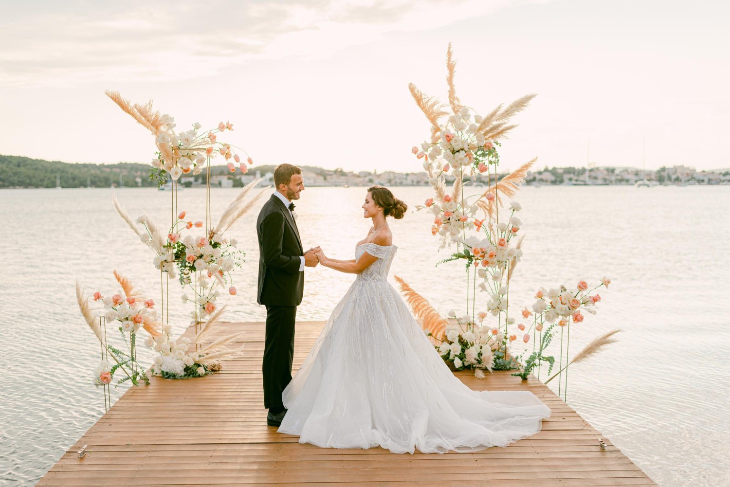 Couple getting married on a deck out to the sea