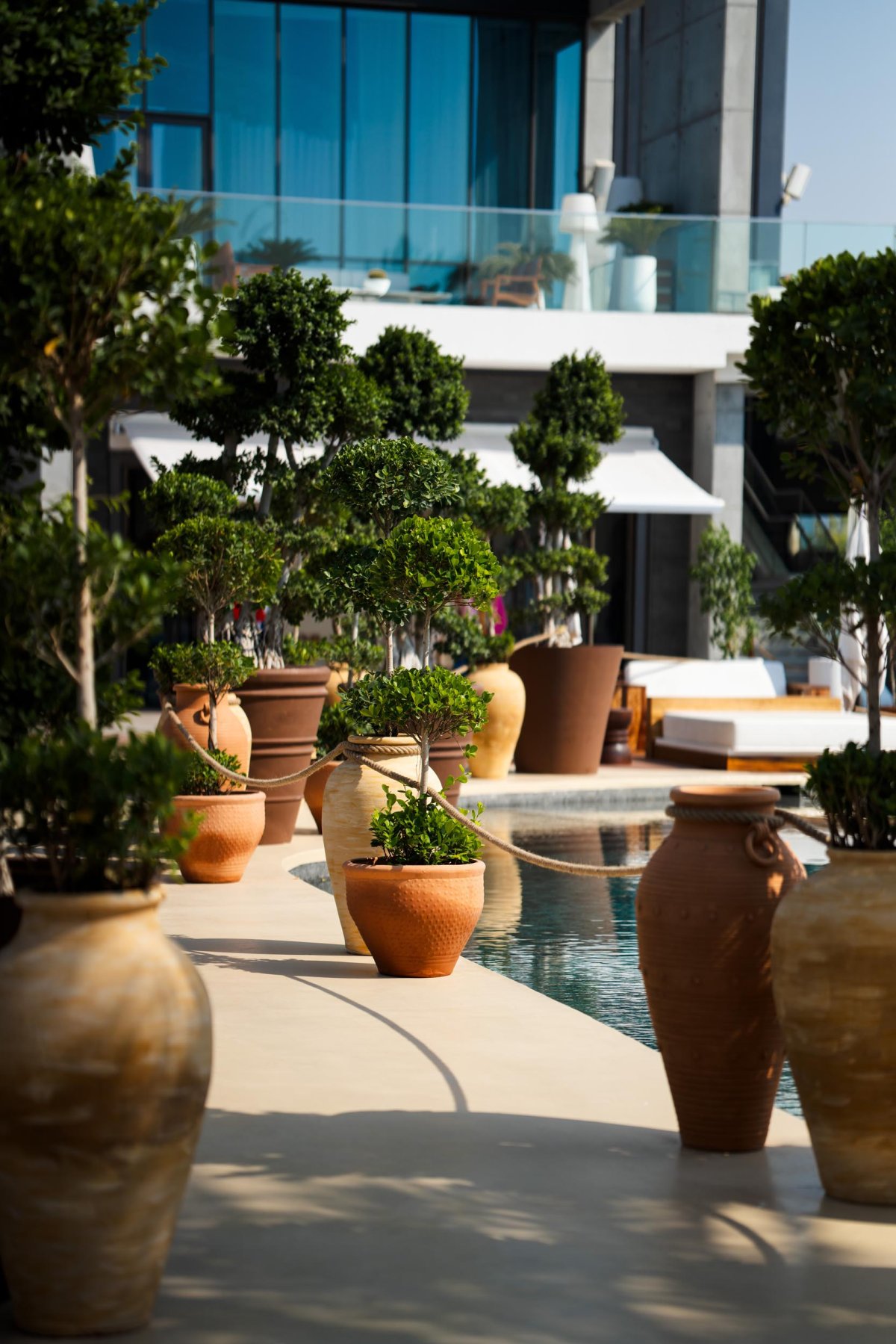 Multiple vases along the edge of the pool