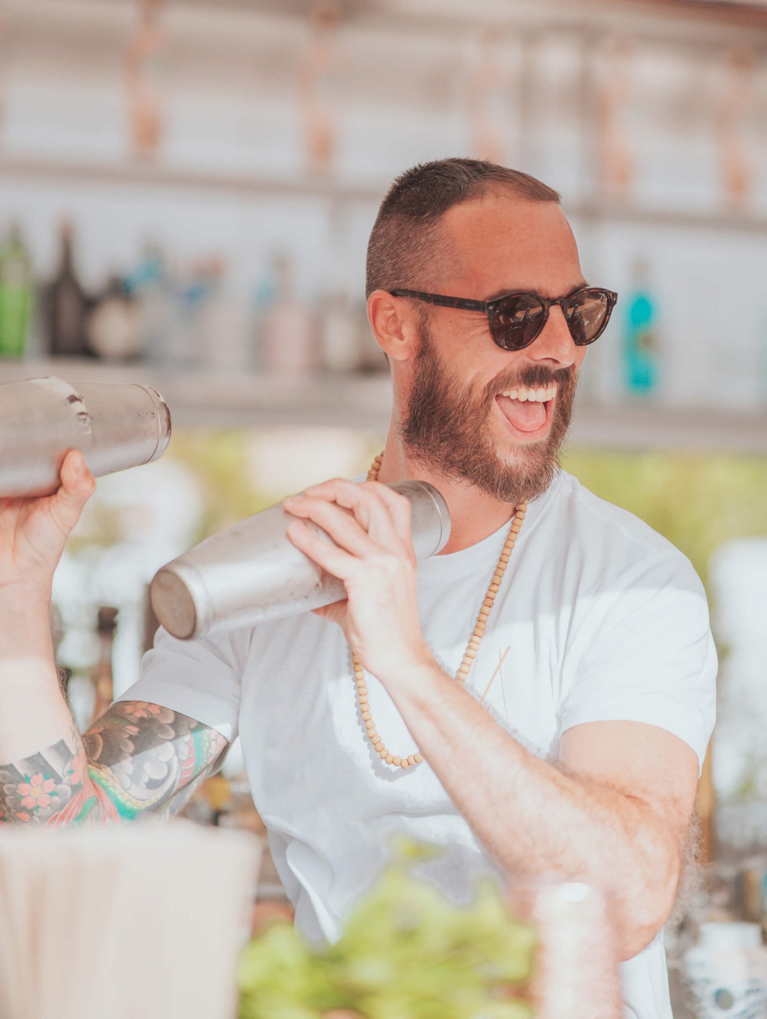 Bartender shaking cocktails smiling