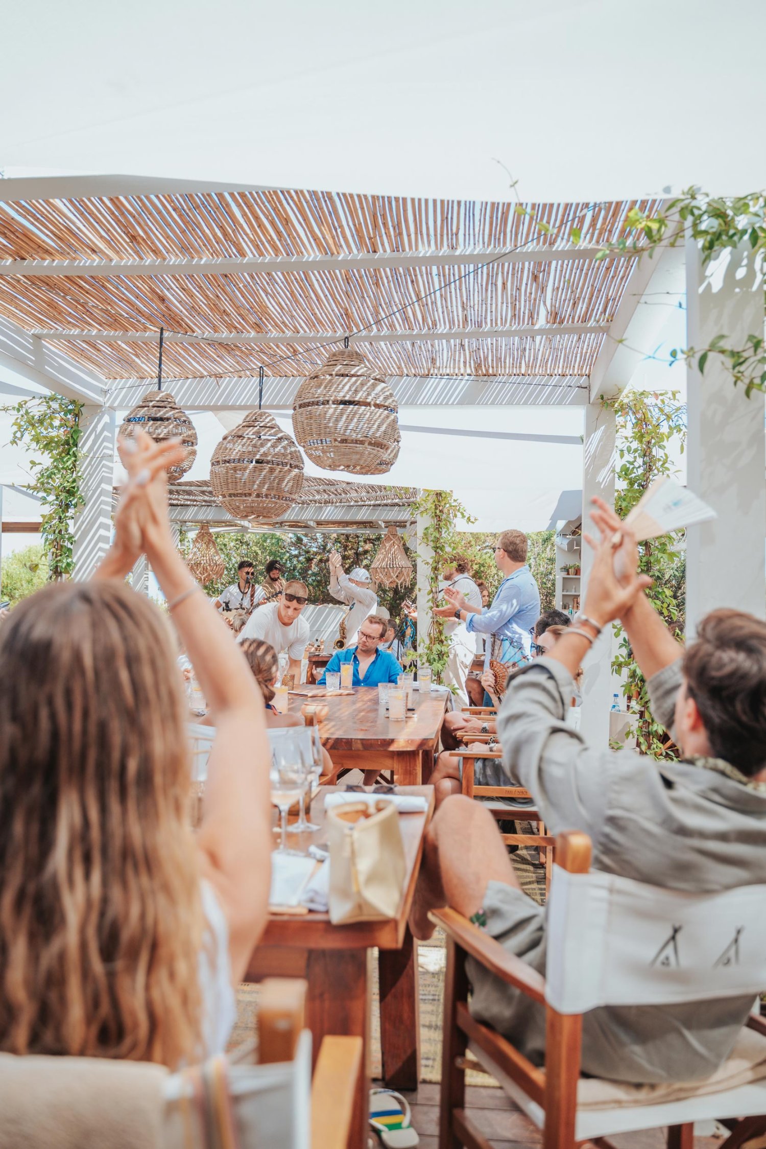 Group of people sat at tables, clapping