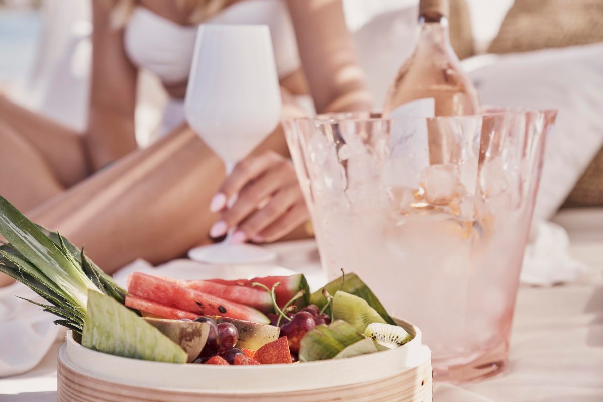 fruit platter next to an ice bucket of wine