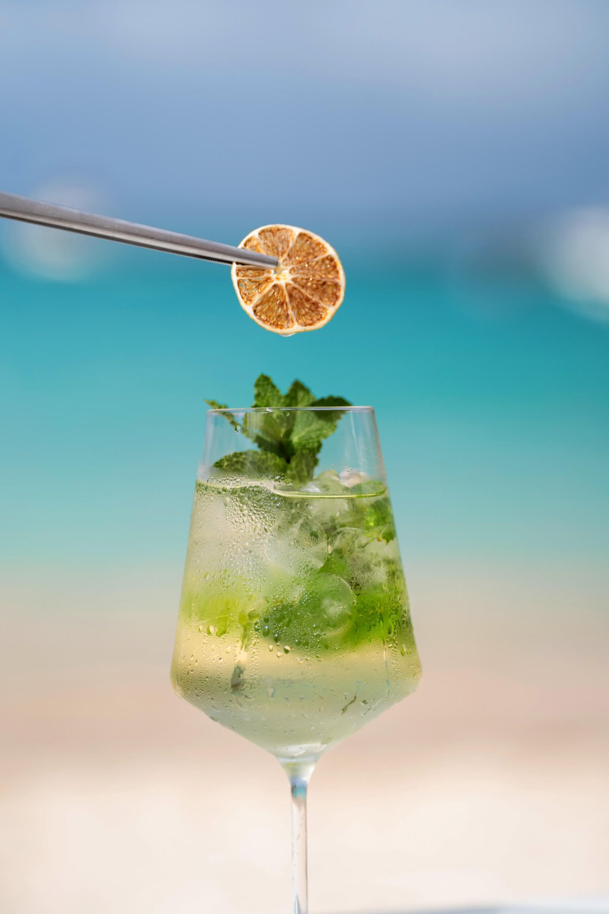 Mojito being topped of with garnish using tweezers