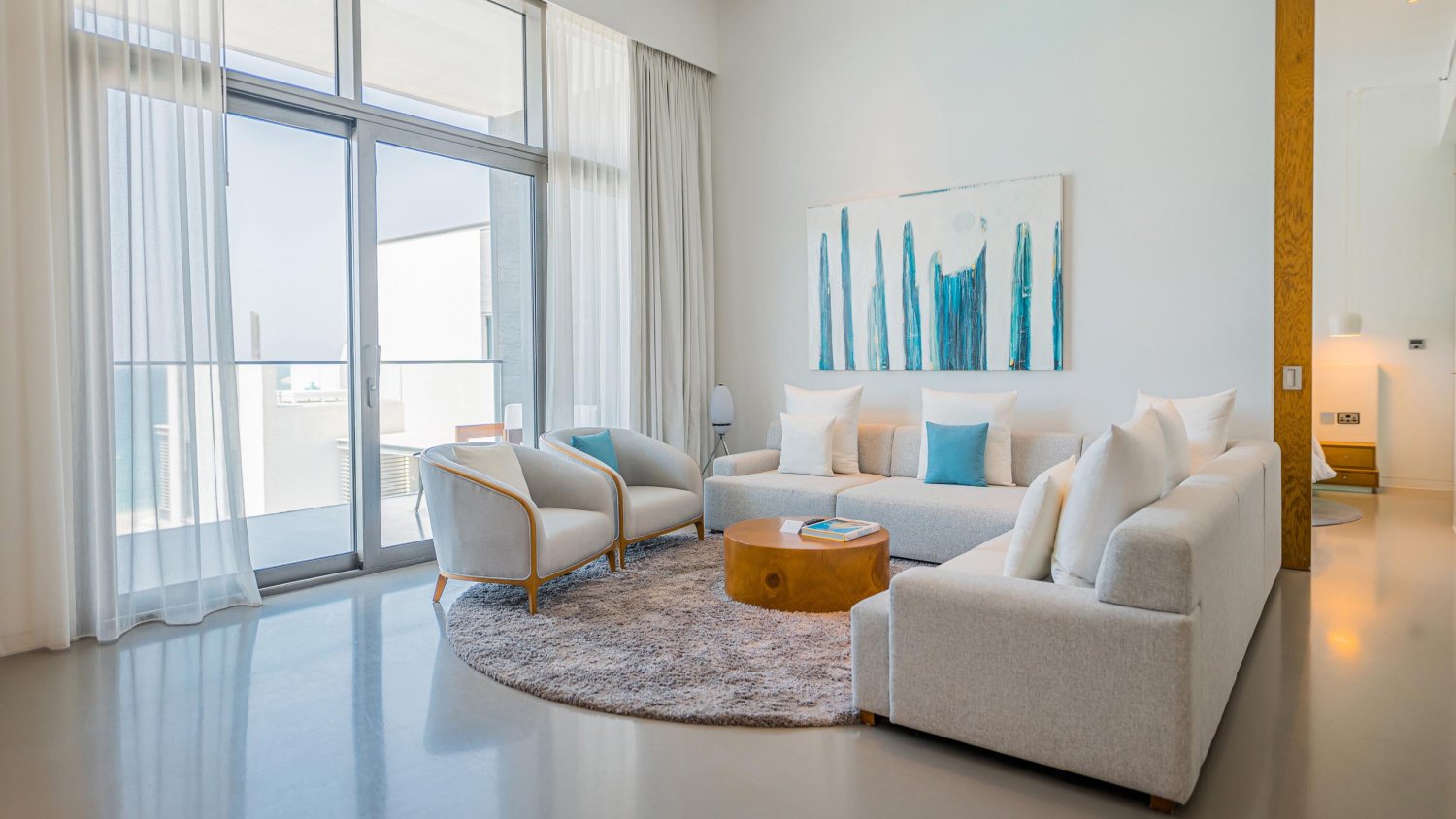 Large L shaped sofa next to arm chairs and small coffee table