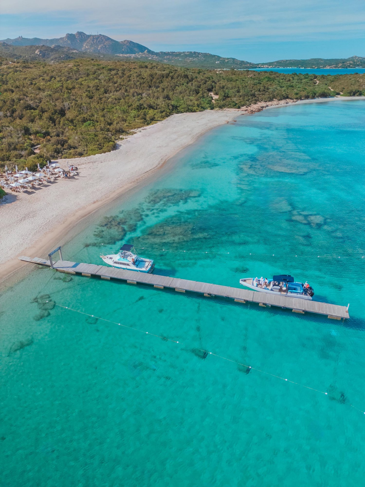 ariel shot of boat dock along a beach