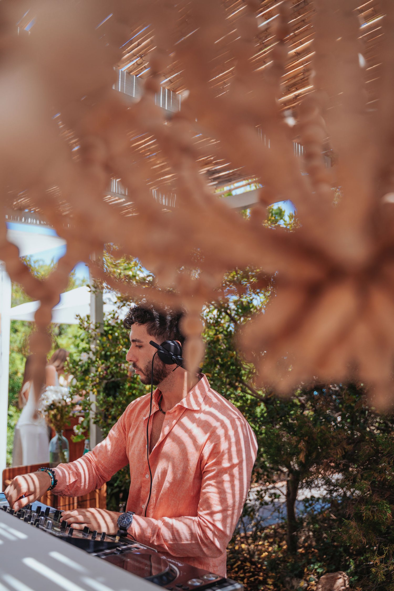 a man wearing headphones, mixing on mixing decks