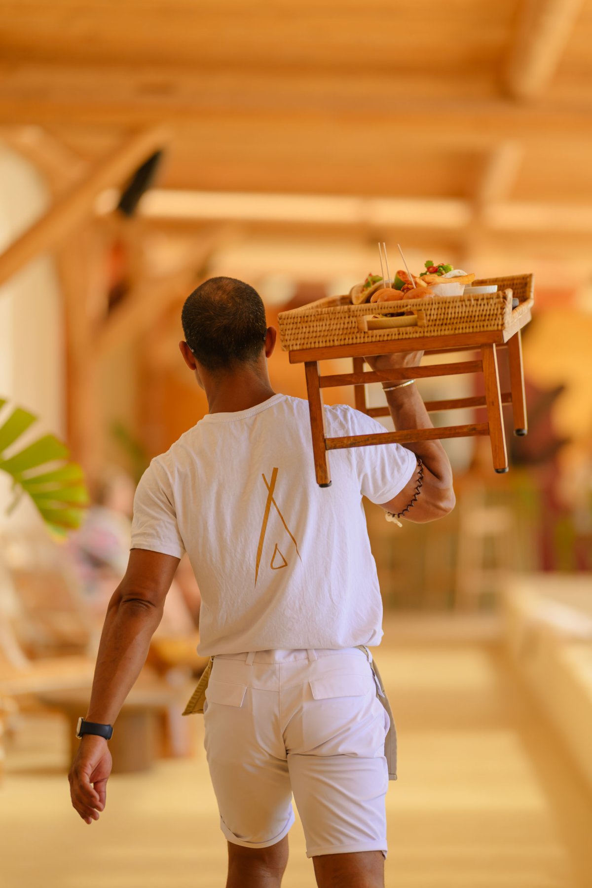 a waiter carrying a platter of food on his shoulder