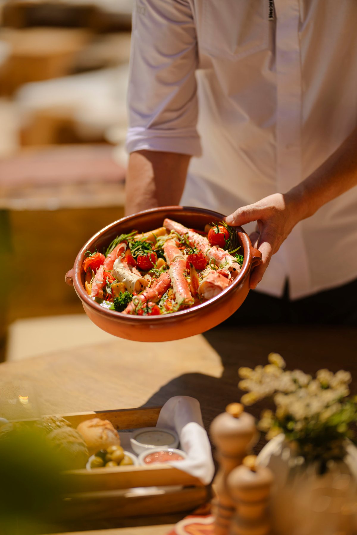 Waiter serving a crab dish at the table
