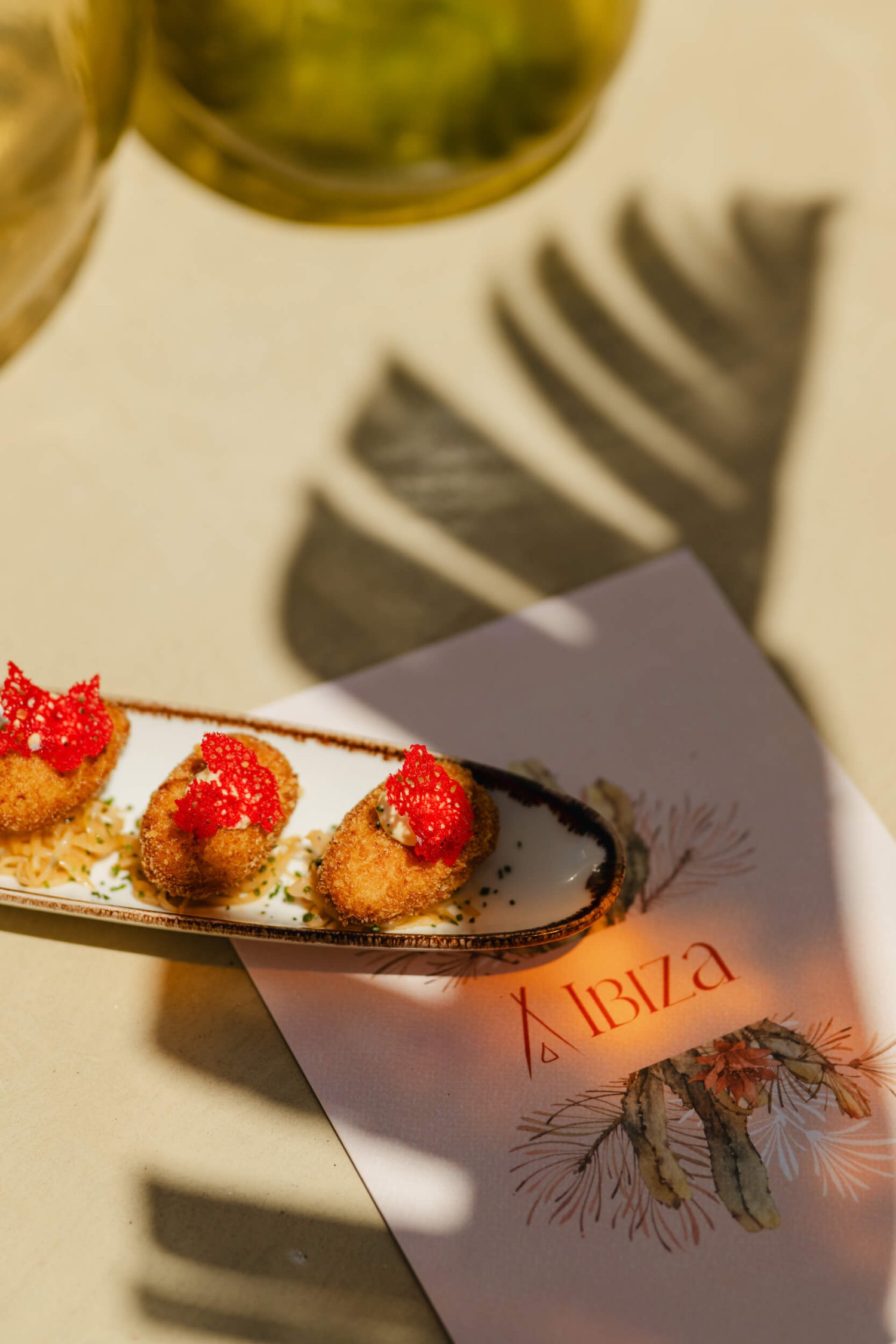Appetizers on a serving plate on top of a Nikki Beach Ibiza menu