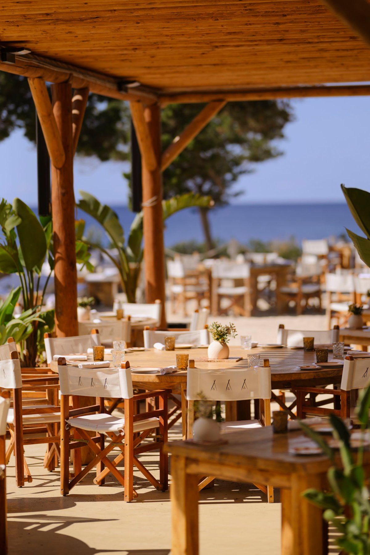 An outdoor shot of a large, round dining table at nikki beach