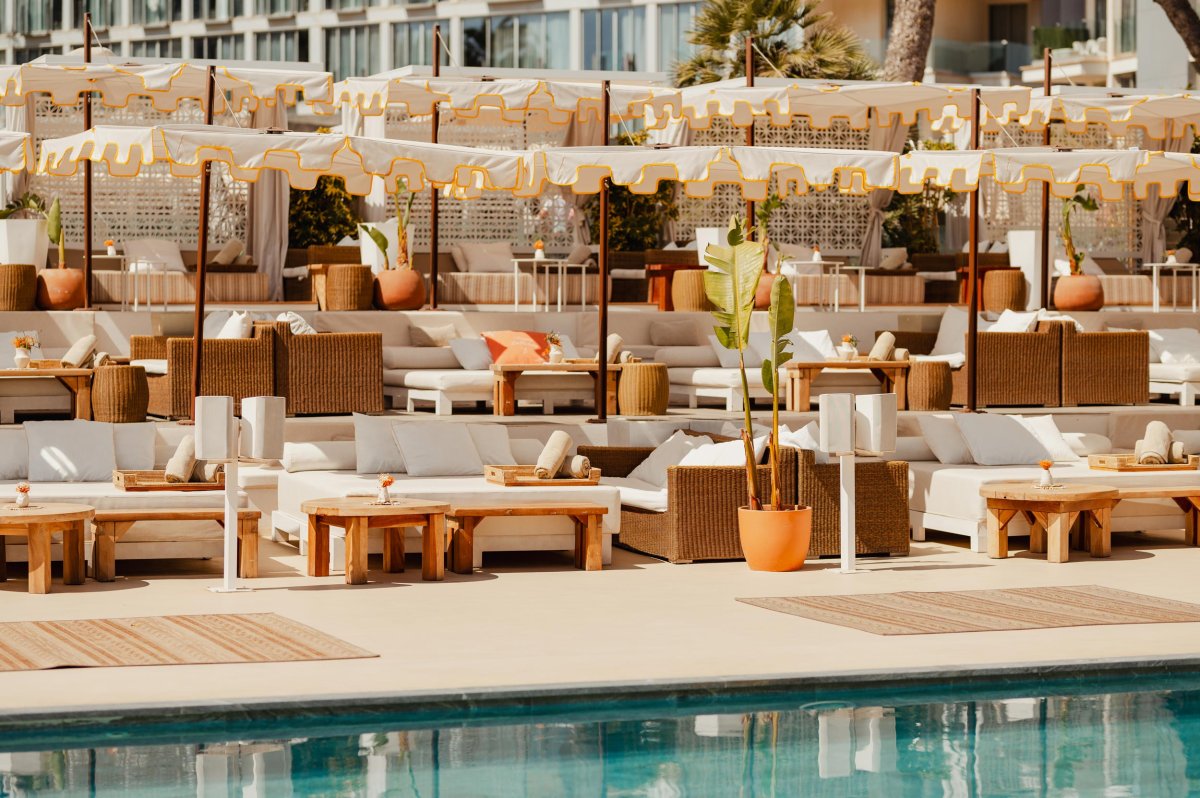 Mallorca pool area showing sofas, sun beds and Nikki beach umbrellas