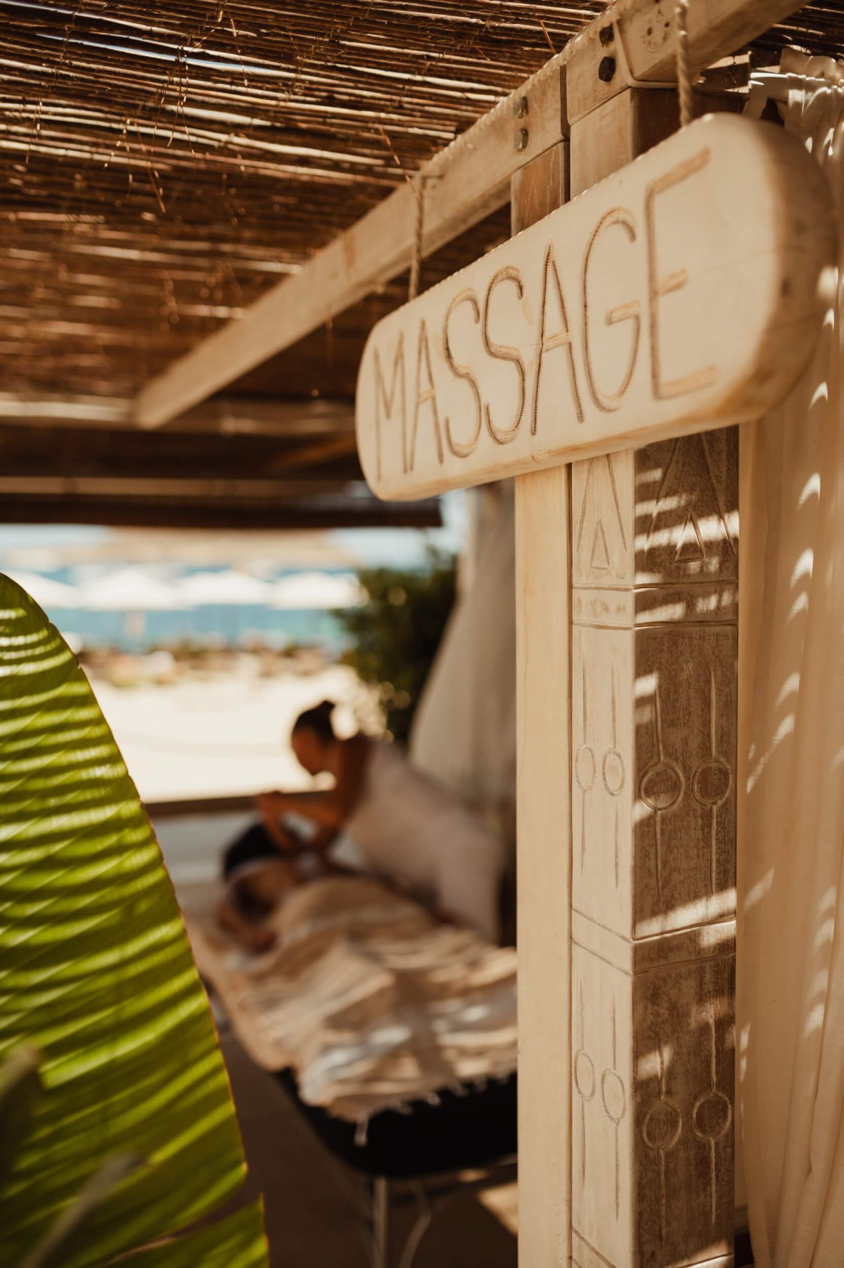 Wooden sign which displays 'Massage'